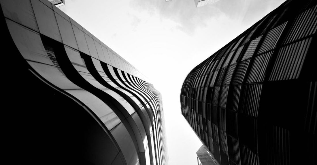 Frameworks - Black and white photo of tall buildings